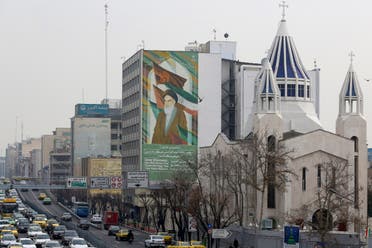A view of the Saint Sarkis Armenian Cathedral, next to a building bearing a drawing of the late founder of the Islamic republic Ruhollah Khomeini, in Tehran on January 1, 2020. (AFP)