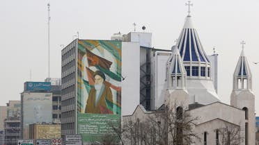 A view of the Saint Sarkis Armenian Cathedral, next to a building bearing a drawing of the late founder of the Islamic republic Ayatollah Ruhollah Khomeini, in Tehran on January 1, 2020. (AFP)