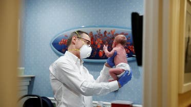 A doctor performs a checkup on a young baby amid the coronavirus outbreak in New York, US, April 13, 2020. (Reuters)