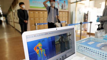 A students gets his temperature checked with a thermal imaging camera as a high school reopens, following the global outbreak of coronavirus disease (COVID-19), in Chungju, South Korea. (Reuters)