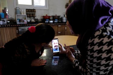 A Palestinian woman video calls her husband with her daughter after the coronavirus pandemic forced them to be apart. (File photo: Reuters)