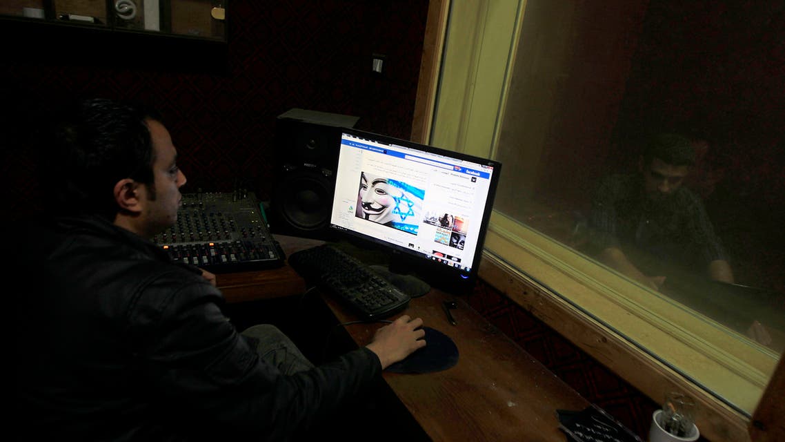 A Palestinian man looks at Facebook page with a picture depicting the #Op_Israel campaign launched by the activist group Anonymous, in Gaza City on April 7, 2013. (File photo: AP)