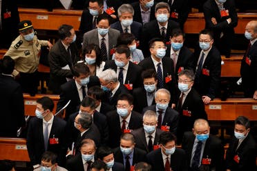 Delegates wearing face masks to protect against the spread of the new coronavirus leave after the opening session of the Chinese People's Political Consultative Conference (CPPCC) at the Great Hall of the People in Beijing on May 21, 2020. (AP)