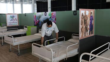 A medical aid worker sets up and installs a bed at a shopping mall, one of Iran's largest, which has been turned into a centre to receive patients suffering from the coronavirus disease (COVID-19), in Tehran. (Reuters)