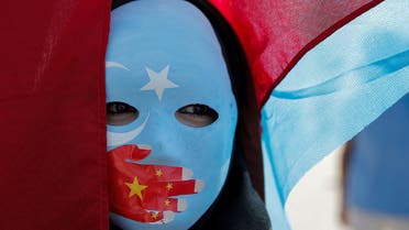 An ethnic Uighur demonstrator wears a mask as she attends a protest against China in front of the Chinese Consulate in Istanbul. (Reuters)