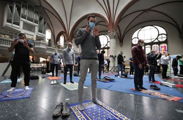 Muslims pray inside the evangelical church of St. Martha's parish, during their Friday prayers, as the community mosque can't fit everybody in due to social distancing rules, in Berlin, on May 22, 2020. (Reuters) 
