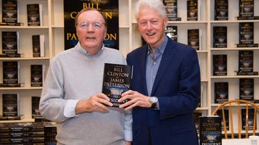 President Bill Clinton, right, and author James Patterson sign copies of “The President is Missing” at Book Revue on June 28, 2018, in Huntington, New York. (AP)