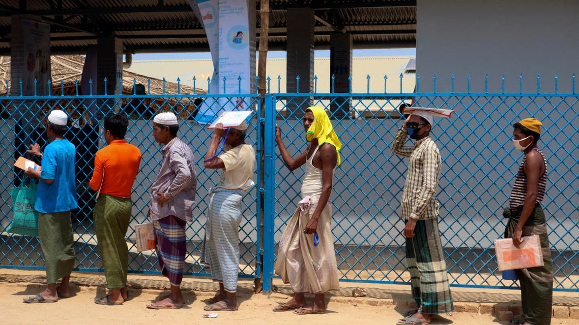 Rohingya refugees stand in line to collect food aid at the Kutupalong refugee camp in Cox's Bazar, Bangladesh, on April 15, 2020. (AP)