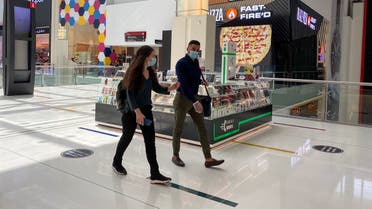 People wearing protective face masks walk at Dubai mall, following the outbreak of the coronavirus in Dubai, United Arab Emirates, May 3, 2020. (Reuters)