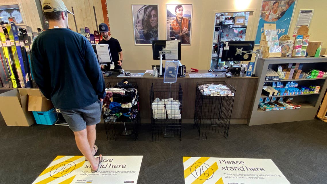 A customer waits at a counter at a shop in Christchurch, New Zealand, on Thursday, May 14, 2020, after the country lifted most of its remaining lockdown restrictions. (AP)