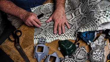 Brian Wood makes snake skin face masks inside his workshop in Delray Beach. (AFP)