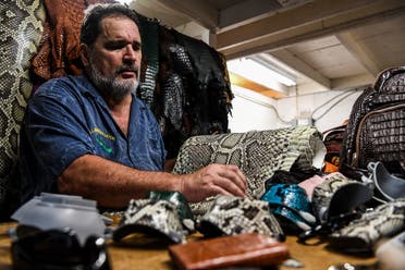 Brian Woods, the 63-year-old owner of All American Gator Products, has turned his hand to designing protective face masks made out reptile skin. (AFP)