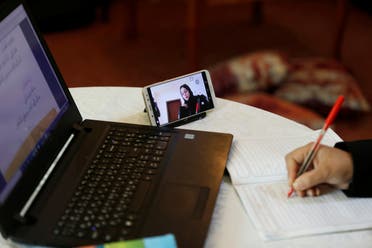 Arabic language teacher Hiba Mohammed teaches an online class from her living room in Amman, Jordan on March 23, 2020. (Reuters)