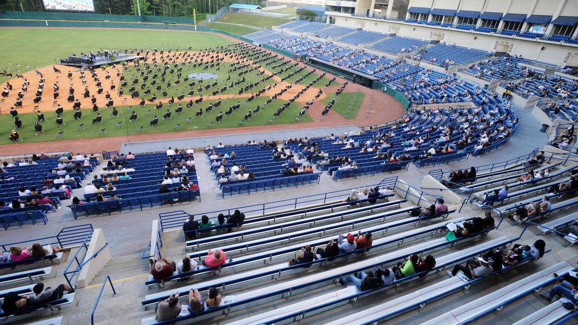 Seniors at Spain Park High School sit on a baseball field during a socially distanced graduation ceremony in Hoover, Alabama, on Wednesday, May 20, 2020. (AP)