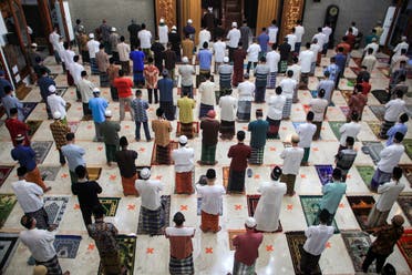 Indonesian Muslims take part in prayers at a mosque during Eid al-Fitr while maintaining social distancing. (Reuters)