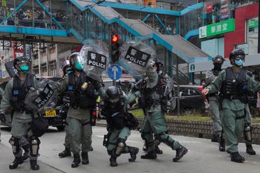 Riot police cover themselves with shields as hundreds of protesters march along a downtown street during a pro-democracy protest against Beijing's national security legislation in Hong Kong, on May 24, 2020. (AP)