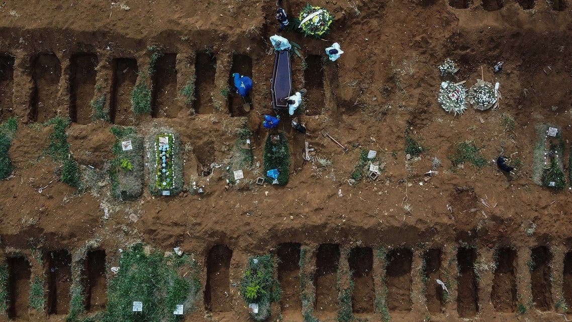Aerial picture showing gravediggers burying an alleged COVID-19 victim at the Vila Formosa Cemetery, in the outskirts of Sao Paulo, Brazil on May 22, 2020. (AFP)