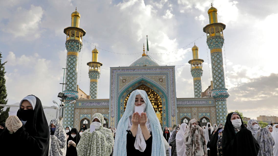 Worshippers wearing protective face masks offer Eid al-Fitr prayers outside a shrine to help prevent the spread of the coronavirus, in Tehran, Iran onMay 24, 2020. (AP)