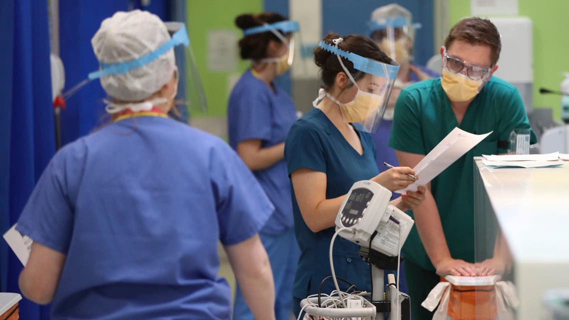 Medical staff wearing face masks and shields to protect against coronaviurs, work in the respiratory emergency department at Craigavon Area Hospital in Co Armagh, Northern Ireland on May 4, 2020. (AP)