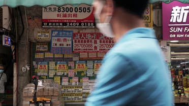 A man wearing a face mask walks past a shuttered shop space covered in rental advertisements, after the border between Shenzhen and Hong Kong was shut due to the coronavirus disease (COVID-19) outbreak, in Hong Kong's northern town of Sheung Shui, China May 18, 2020. (Reuters)