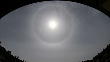 A halo, an optical phenomena from sunlight and ice crystals, forms around the sun above Cernusco sul Naviglio, near Milan, Italy, April 16, 2020. (Reuters)