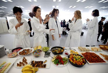 Models eat food backstage before Christian Dior's Haute Couture Spring-Summer 2017 live show to celebrate Dior's new flagship store at the Ginza Six mall in Tokyo, Japan, April 19, 2017. (Reuters)