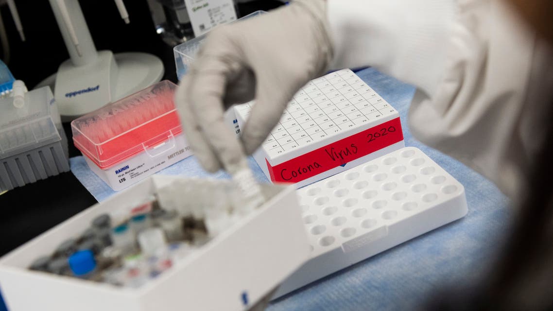 Dr. Nita Patel, Director of Antibody discovery and Vaccine development, lifts a vial with a potential coronavirus, COVID-19, vaccine at Novavax labs in Gaithersburg, Maryland on March 20, 2020, one of the labs developing a vaccine for the coronavirus, COVID-19.