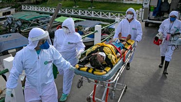 Health personnel carry Brazilian Eladio Lopes, 79, infected with the new coronavirus, on Marajo island in Brazil, on May 25, 2020. (AFP)