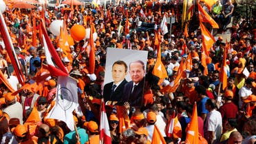 Supporters of the Free Patriotic Movement (FPM) carry flags and a picture of Christian politician and FPM founder Michel Aoun (R) and Lebanese Foreign Minister and head of the Free Patriotic Movement (FPM) Gebran Bassil, during a rally to show support for Aoun and calling to elect a president, near the presidential palace in Baabda, near Beirut, Lebanon October 16, 2016. (Reuters)