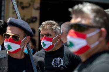 Anti-government protesters wear masks with the colors of the Lebanese flag in Beirut on May 18, 2020. (AP)