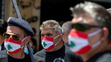 Anti-government protesters wear masks with the colors of the Lebanese flag in Beirut on May 18, 2020. (AP)