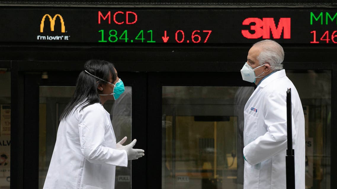 Health care screeners talk outside the New York Stock Exchange, as the trading floor partially reopens on Tuesday, May 26, 2020, in New York. (File photo: AP)