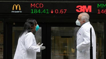 Health care screeners talk outside the New York Stock Exchange, as the trading floor partially reopens on Tuesday, May 26, 2020, in New York. (AP)