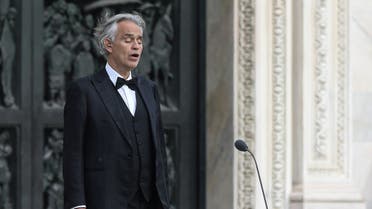 This photo taken on April 12, 2020 shows Italian tenor and opera singer Andrea Bocelli sing during a rehearsal on a deserted Piazza del Duomo in central Milan, prior to an evening performance without public for the world wounded by the pandemic, during the country's lockdown aimed at curbing the spread of the COVID-19 infection, caused by the novel coronavirus. (AFP)