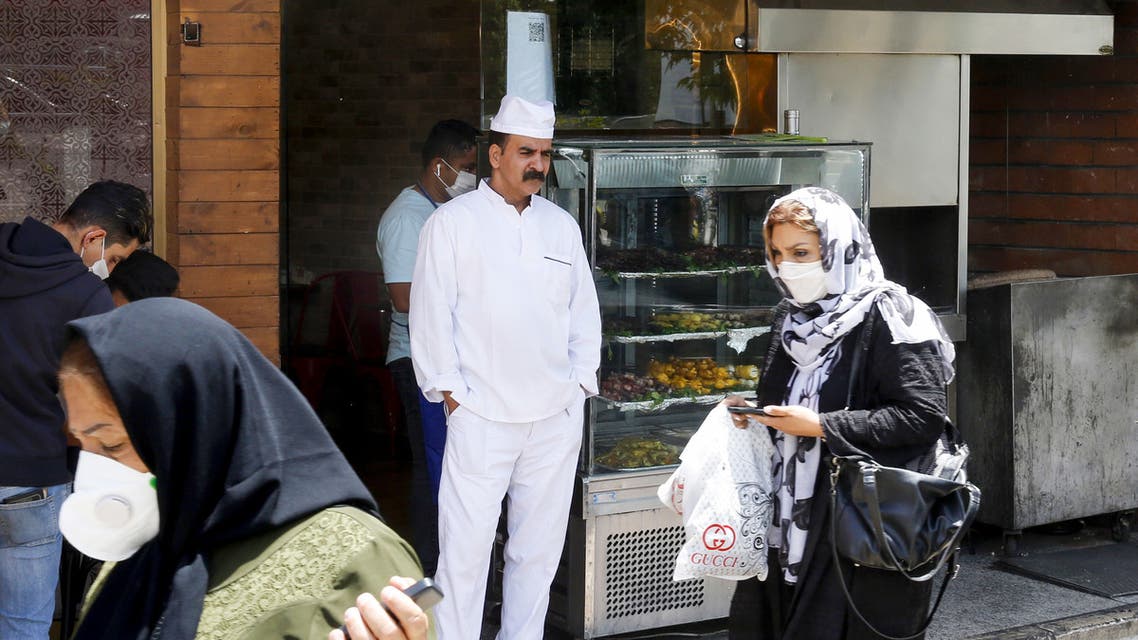 Iranians pass by a restaurant in the capital city of Tehran, on May 26, 2020. (AFP)