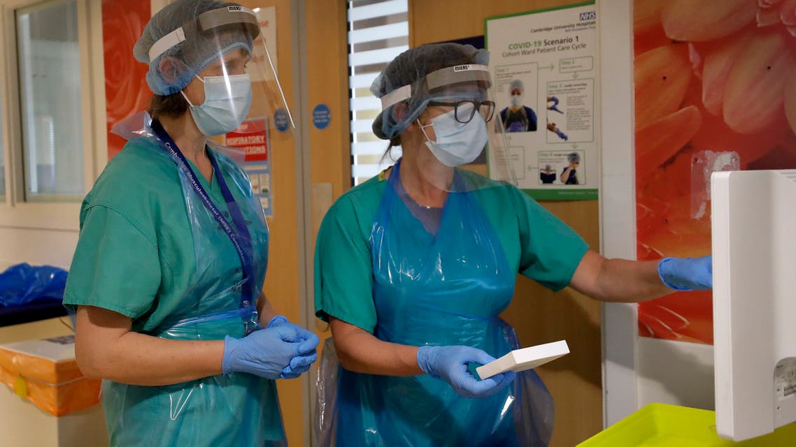 Stella Burns, Lead Clinical Nurse Specialist, right, and Frances Hall, Consultant Rheumatologist prepare medication for a patient taking part in the TACTIC-R trial at Addenbrooke's hospital in Cambridge, England on May 21, 2020. (AP)