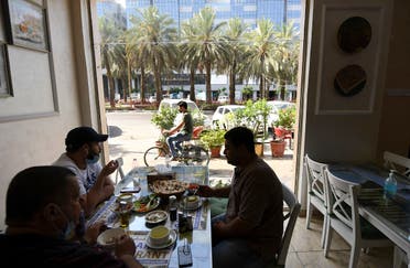 People sit at restaurant in Dubai on May 26, 2020 as the Gulf emirate moved to ease their lockdown measures amid the COVID-19 coronavirus pandemic. (AFP)