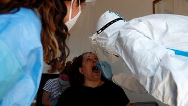 In this Monday, May 25, 2020 photo, medical staff conduct tests for coronavirus on the local residents, on the Aegean Sea island of Folegandros, Greece. (AP/Thanassis Stavrakis)