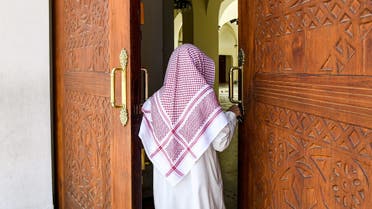 Imam Mohammed, muezzin of the Jaffali mosque in Saudi Arabia's Red Sea coastal city of Jeddah, enters the mosque which is closed due to a government decree as part of efforts to combat the COVID-19 coronavirus pandemic, during the Muslim holy month of Ramadan on April 28, 2020. (AFP)