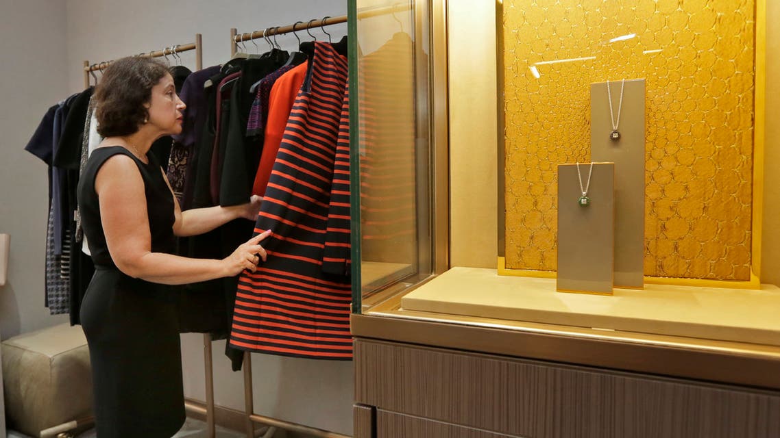 Associated Press writer Anne D'Innocenzio looks through outfits in one of the Fifth Avenue Club's private rooms at the Saks Fifth Avenue flagship store, in New York. (AP)