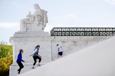 Women exercise on the steps of the US Supreme Court on May 4, 2020, in Washington. (AP)