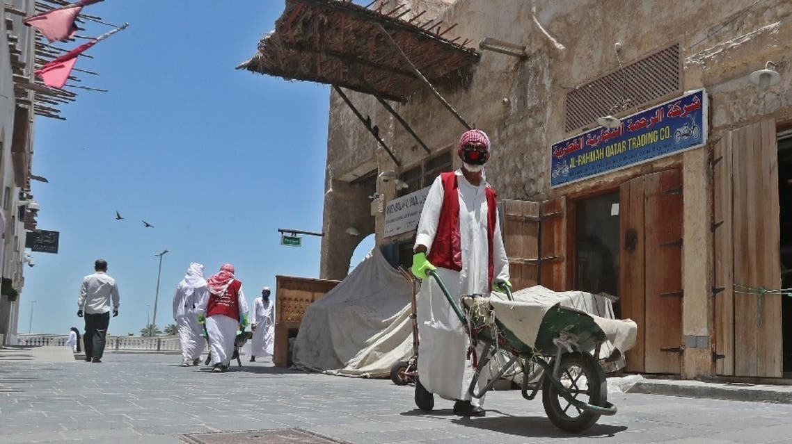 Members of staff wearing masks work at Qatar's touristic Souq Waqif bazar in the capital Doha, on May 17, 2020. (AFP)