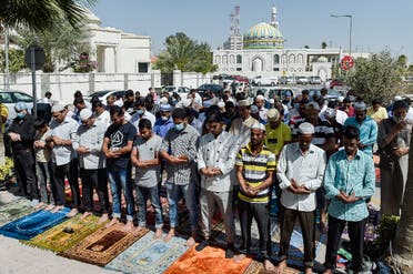 Muslim worshippers, some wearing protective masks, perform together Friday prayers outside a mosque in Bahrain's capital Manama on February 28, 2020. (AFP)