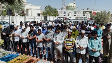Muslim worshippers, some wearing protective masks, perform together Friday prayers outside a mosque in Bahrain's capital Manama on February 28, 2020. (AFP)