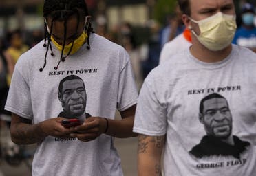 Two men wear shirts stating Rest in Power George Floyd on May 27, 2020 in Minneapolis, Minnesota. (AFP)