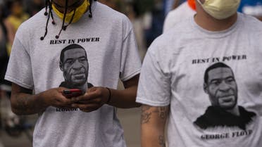 Two men wear shirts stating Rest in Power George Floyd on May 27, 2020 in Minneapolis, Minnesota. (AFP)