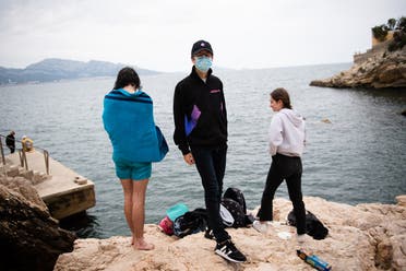 Youths gather at the “Maldorme” cove rocks in Marseille, southeastern France, on May 16, 2020. (AFP)