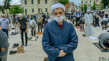 Worshippers wearing protective facemasks maintain the required social distance during the Friday prayer outside The Fatih Mosque in Istanbul on May 29, 2020. (AFP)