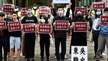 Students from Hong Kong and Taiwan display placards reading “Bad laws of China’s national security during a protest outside the Hong Kong’s Taipei office on May 28, 2020. (AFP)