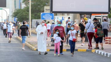 Mask-clad residents walk in a neighbourhood of Kuwait City on May 12, 2020. (AFP)